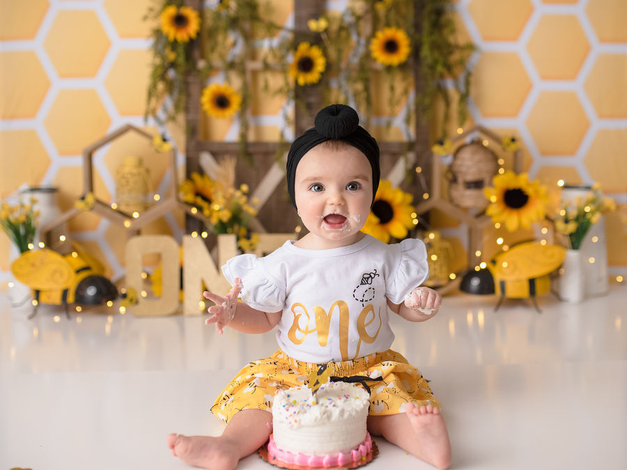 One-year-old at a sunflower and bee cake smash